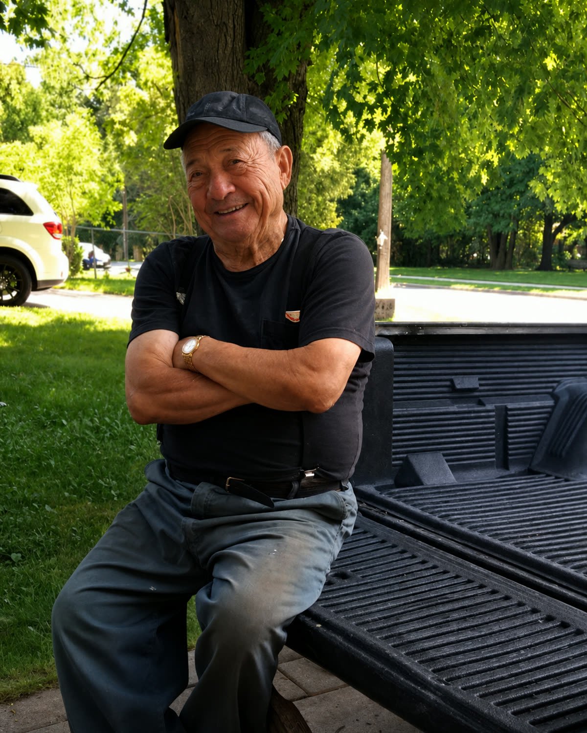 Pietro Gullo, founder of Gullo Brothers Concrete, seated on a pickup tailgate