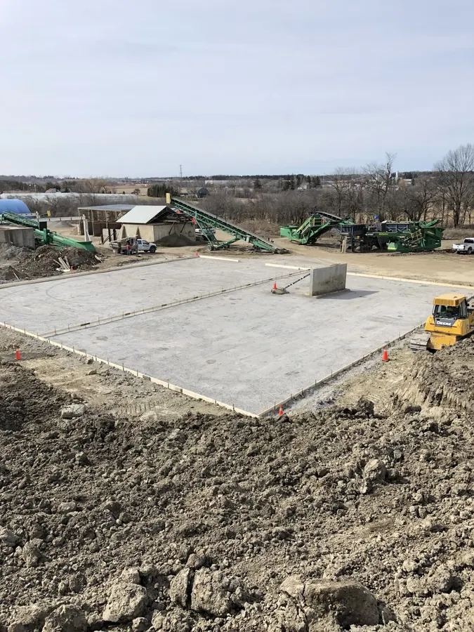 Large finished commercial concrete pad with saw-cut control joints on an engineered base