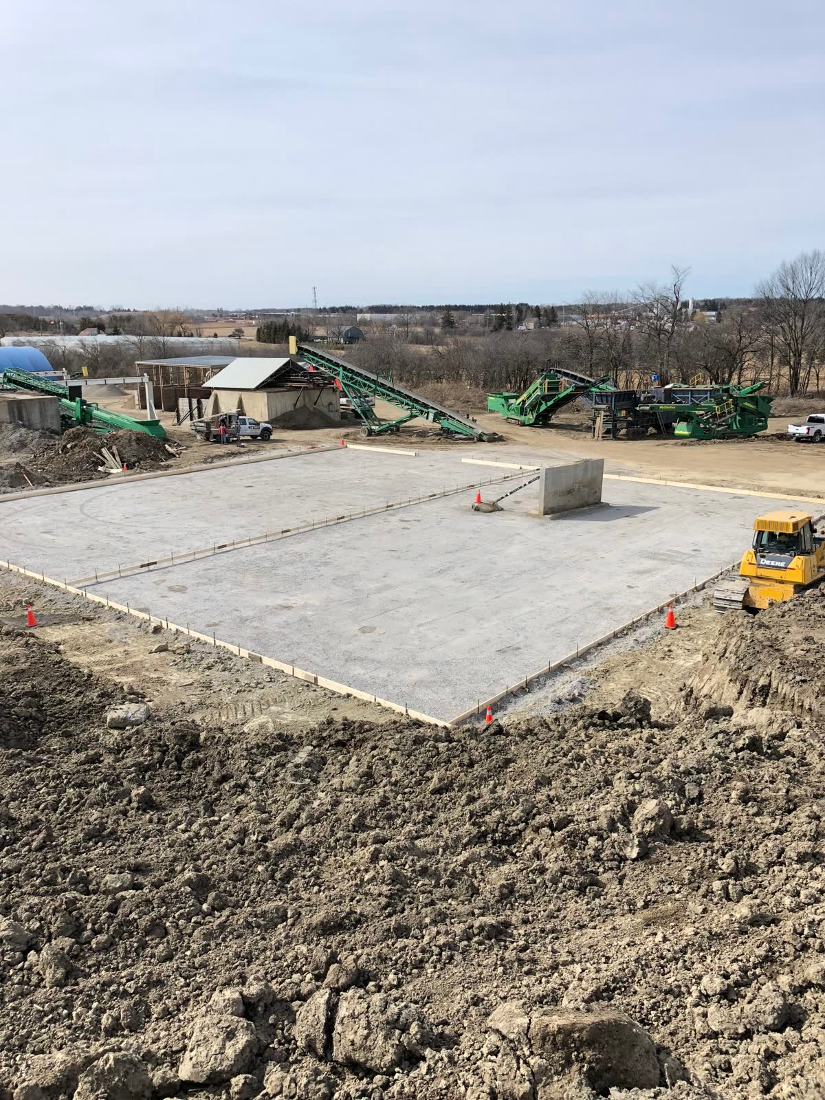 Large finished commercial concrete pad with saw-cut control joints on an engineered base