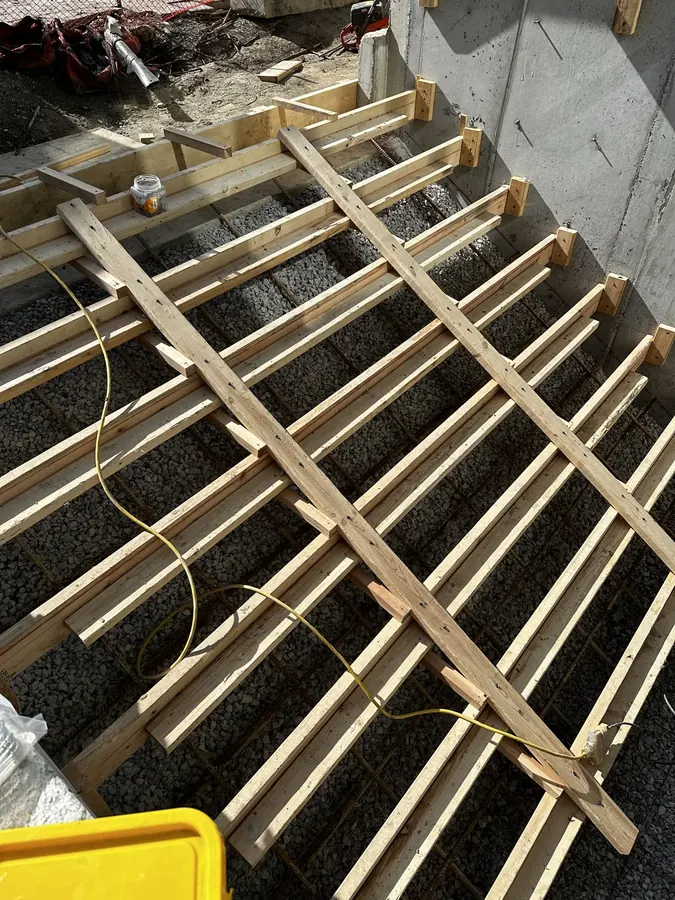 Timber formwork and shoring built over a reinforced gravel base for a structural concrete pour