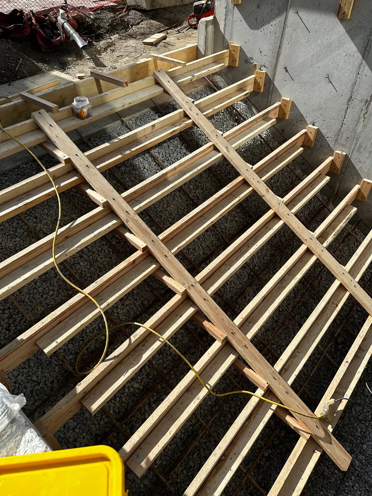 Timber formwork and shoring built over a reinforced gravel base for a structural concrete pour