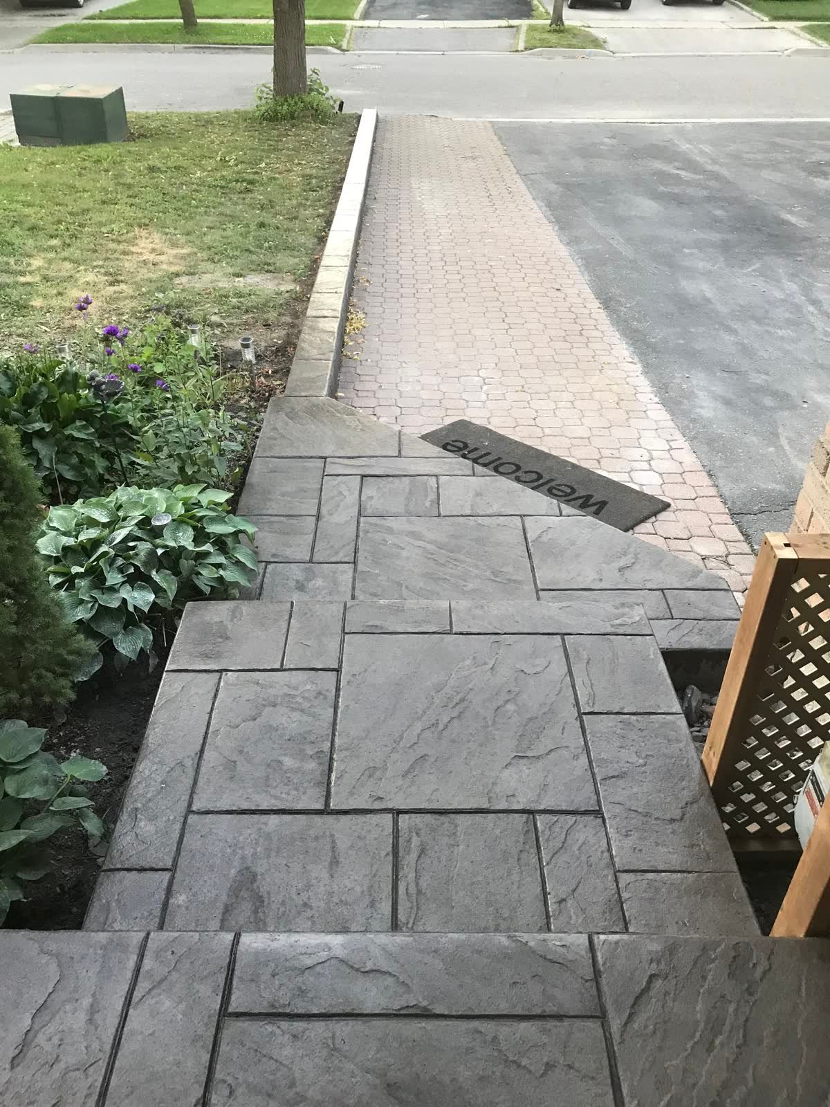 Ashlar-pattern stamped concrete front walkway and landing in slate grey