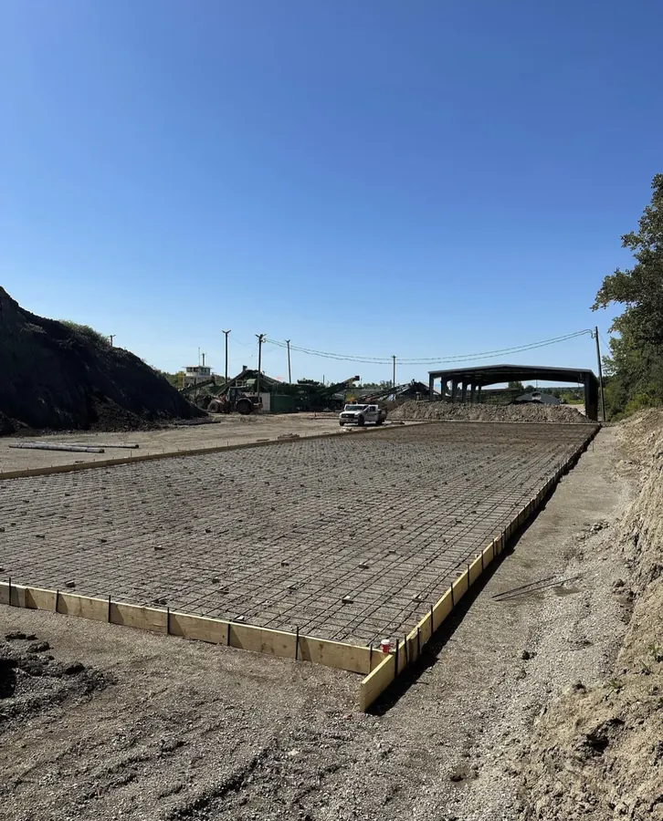 Large reinforced industrial concrete slab formed and tied off with rebar, ready for the pour